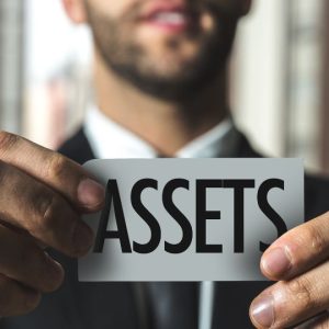 Man holding assets sign