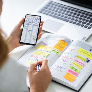 Woman looking at phone calendar and calendar